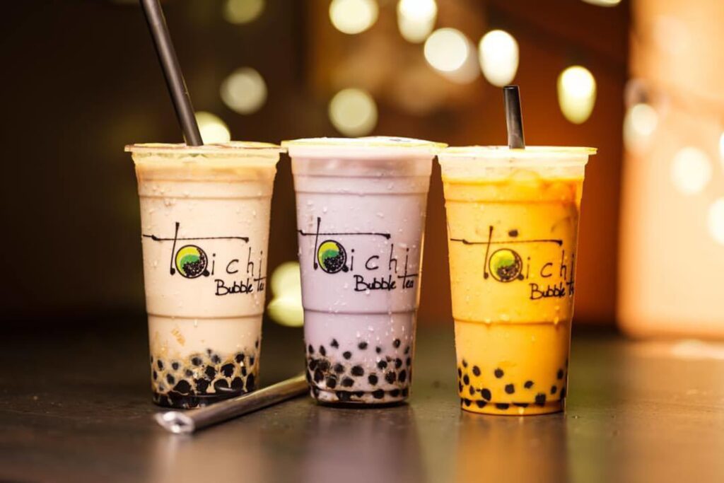 Three different colored Taichi drinks on a table.