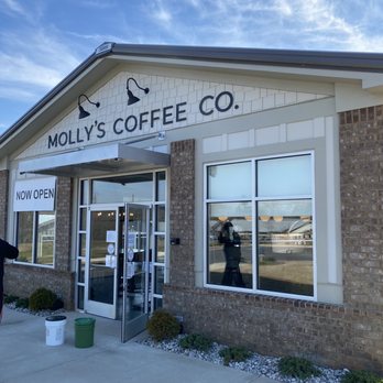 Entrance of Molly's coffe shop with glass doors and windows.