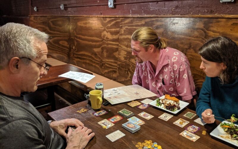 People playing board games at The Rook & Pawn.