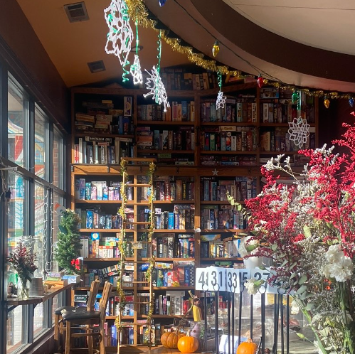 Shelves with boxes of games on them. There's a ladder to reach the games.