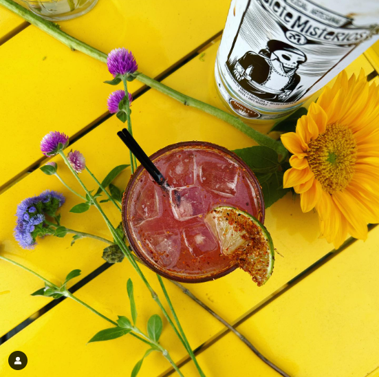 Drink sitting on a yellow table.