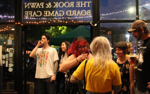 People standing inside The Rook & Pawn.