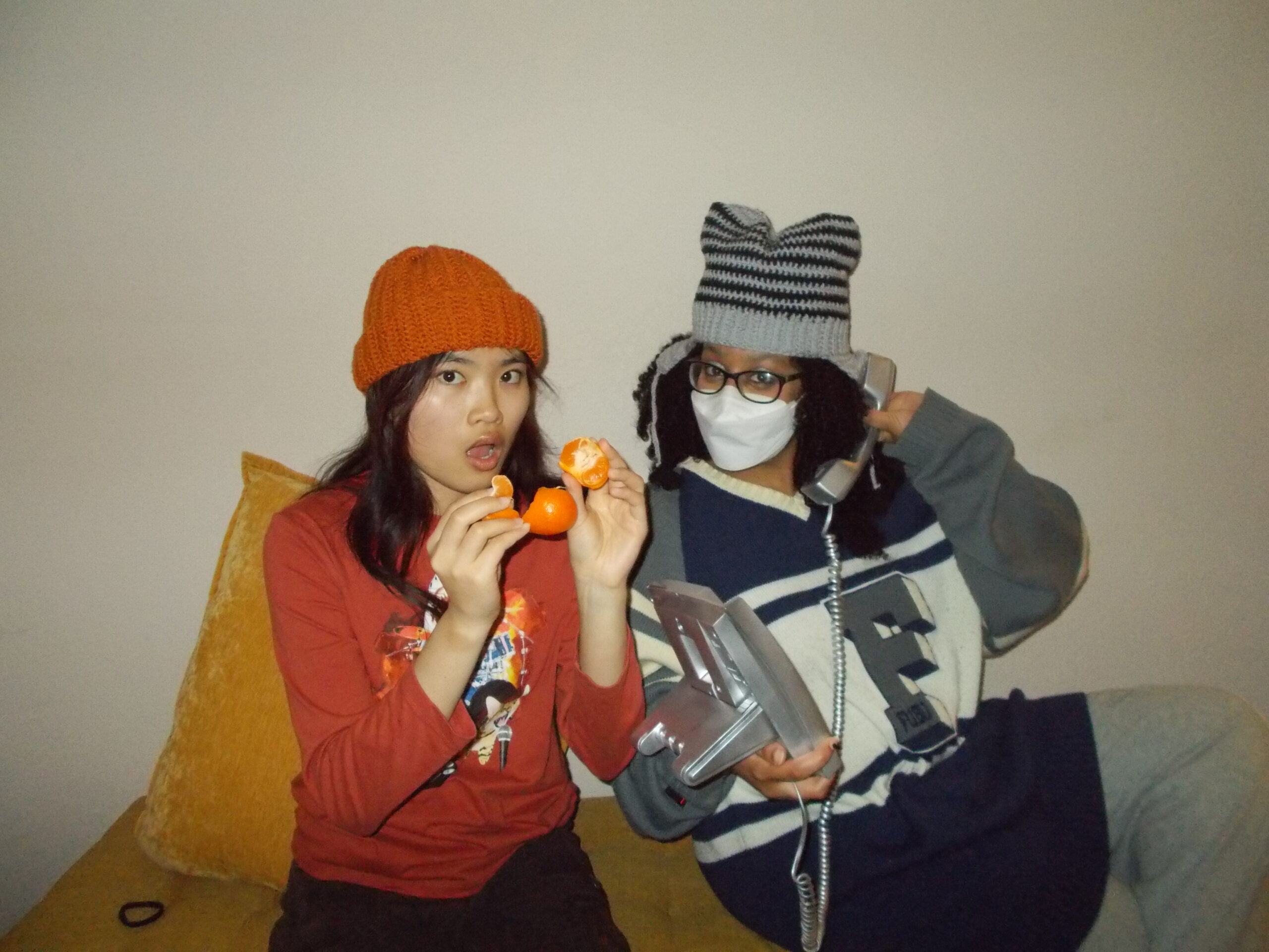 Amanda and Hannah sitting next to each other Hannah is wearing the star beanie and Amanda is wearing the beanie.