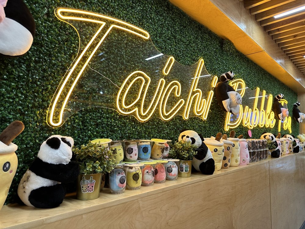 Taichi wall with stuffed pandas and cups.