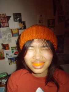 Amanda wearing the beanie with an orange peel grill.