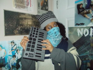 Hannah wearing the cat beanie playing a mini keyboard.