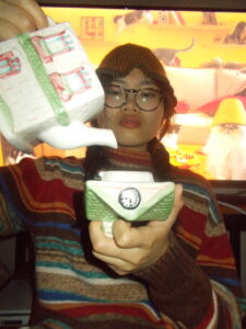 Amanda wearing the bucket hat pouring tea.