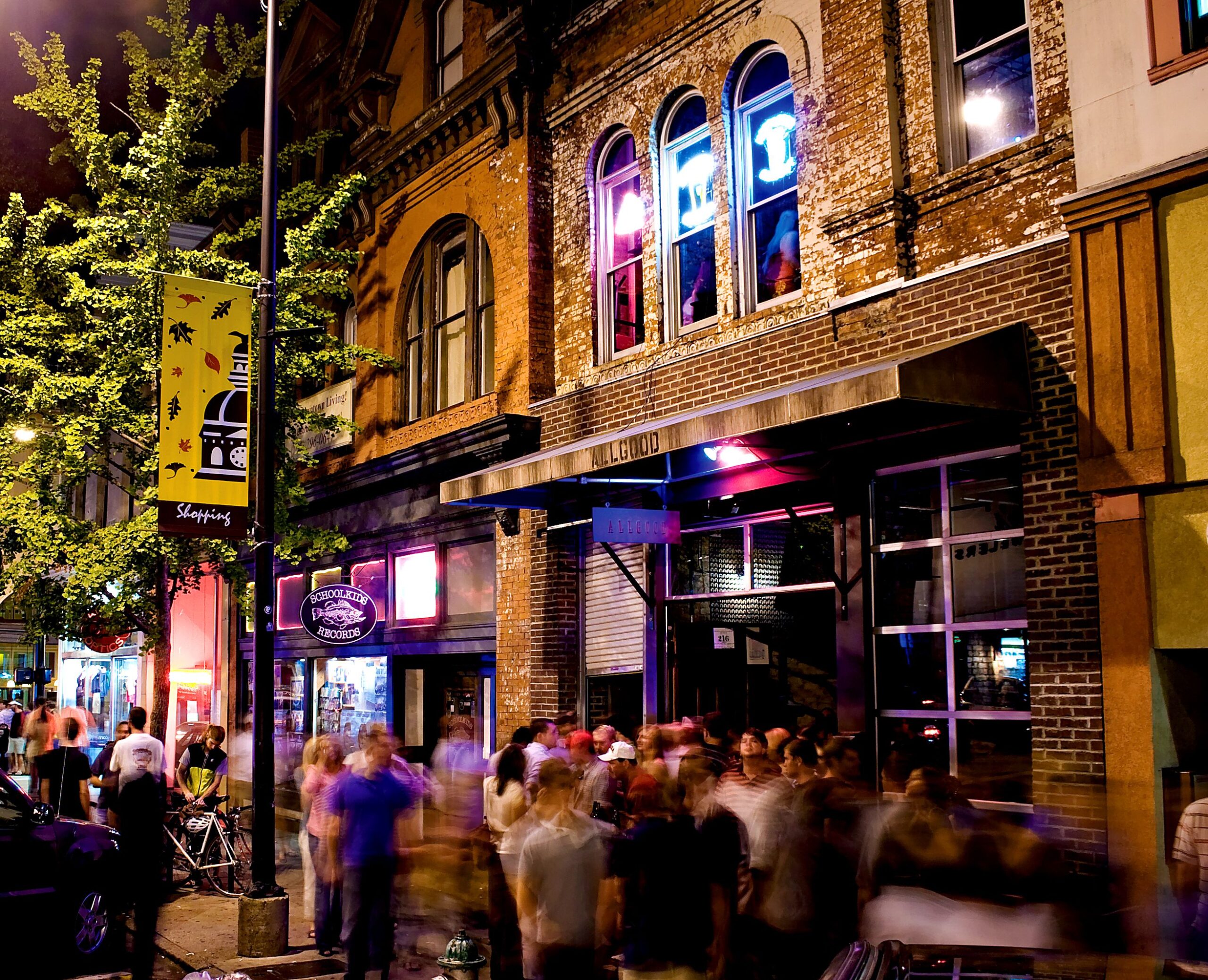 The streets of Athens, GA at night full of people.