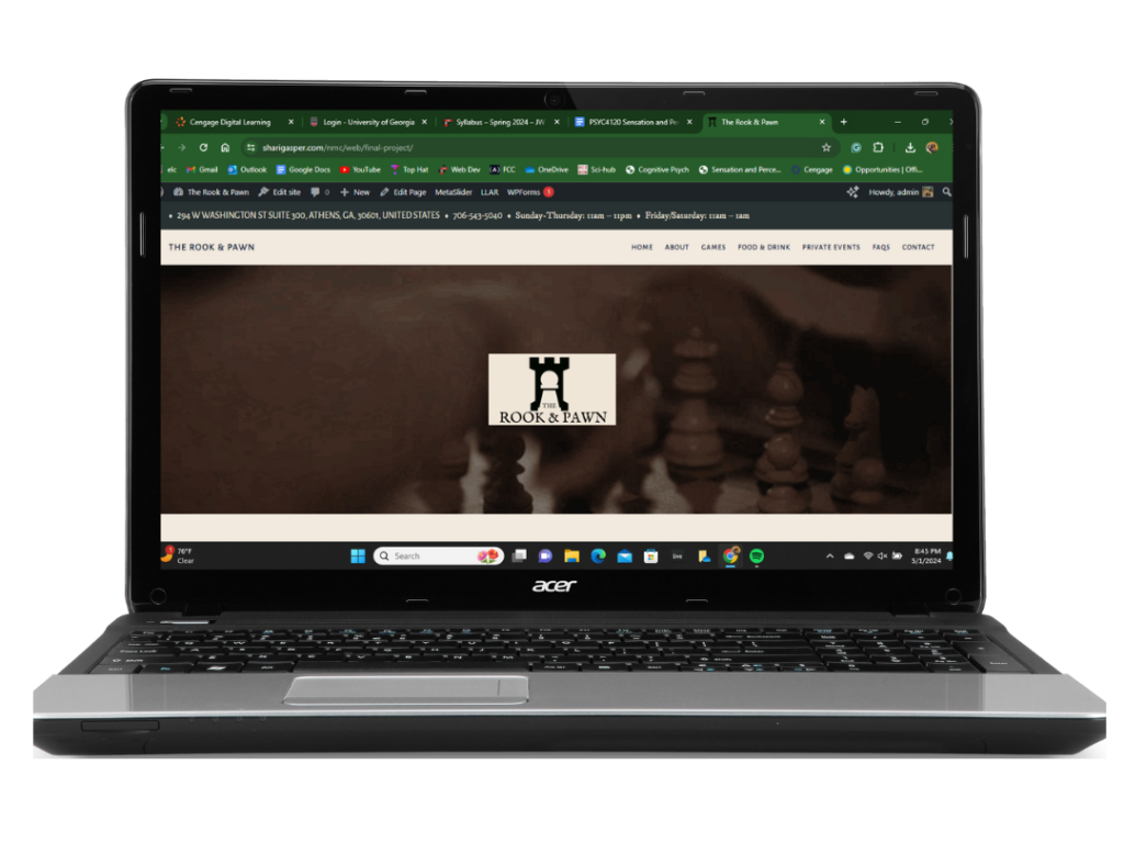 Laptop with The Rook & Pawn website.